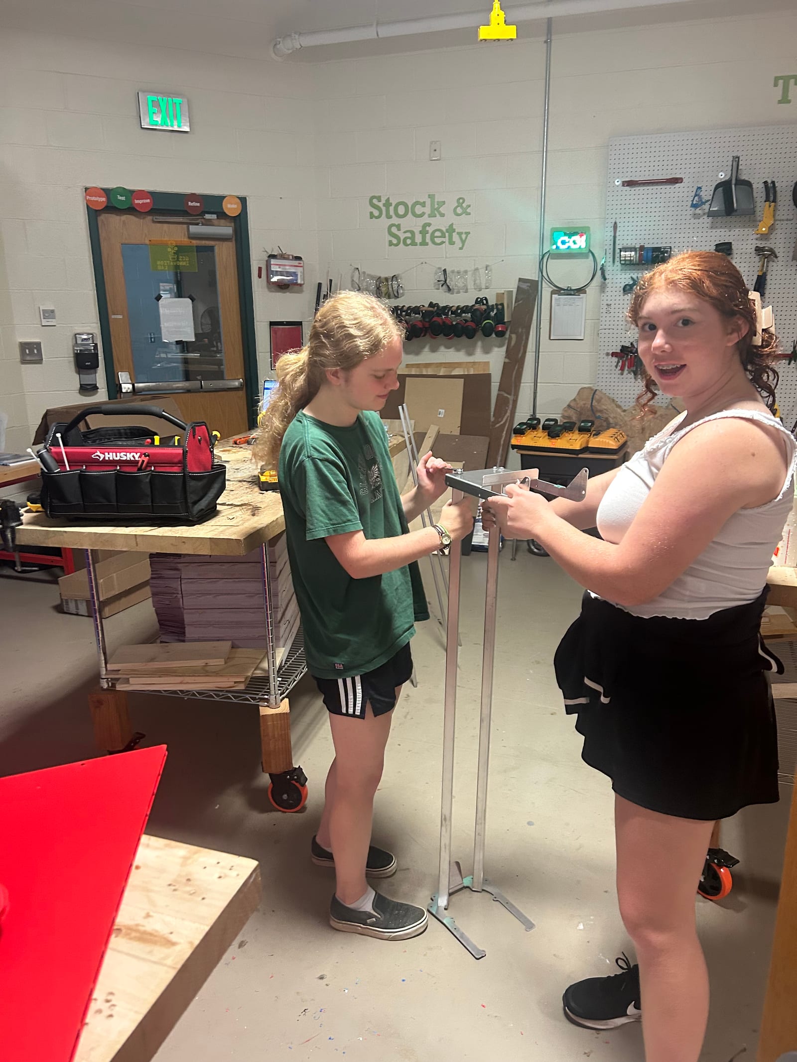 Two students measuring a part for the ramp