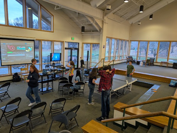 Students playing games in the Forum with big windows behind them