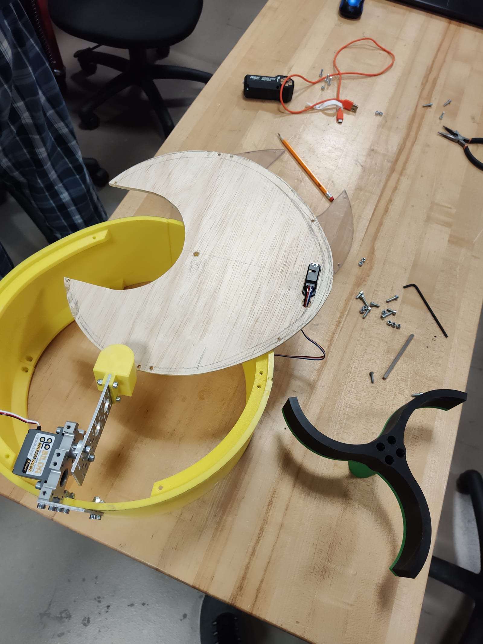 A plywood disc next to the yellow drum ring