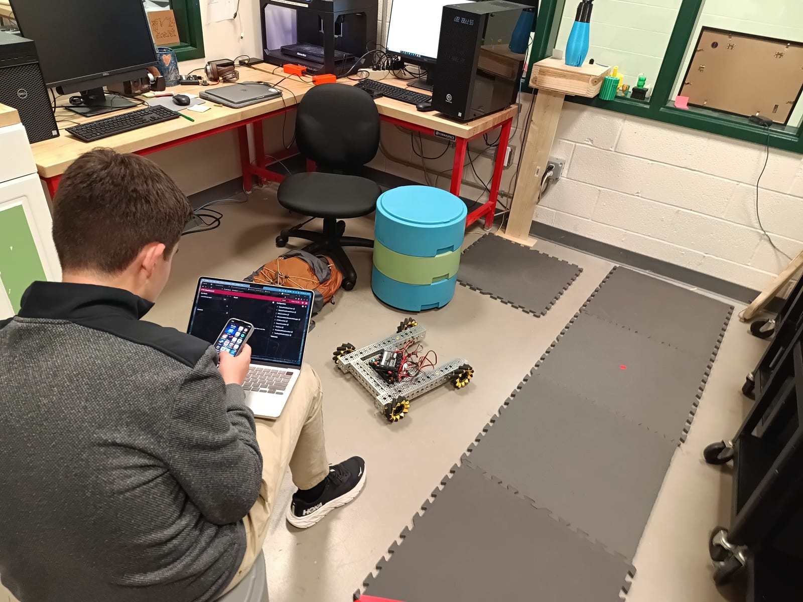 A student at a laptop running FTC Dashboard beside the robot